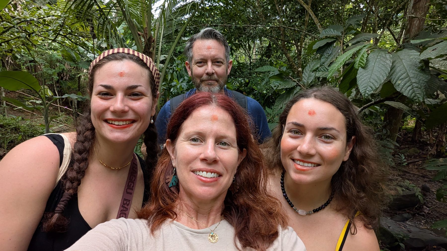 Marybeth and retreat guests smiling together on a jungle trail