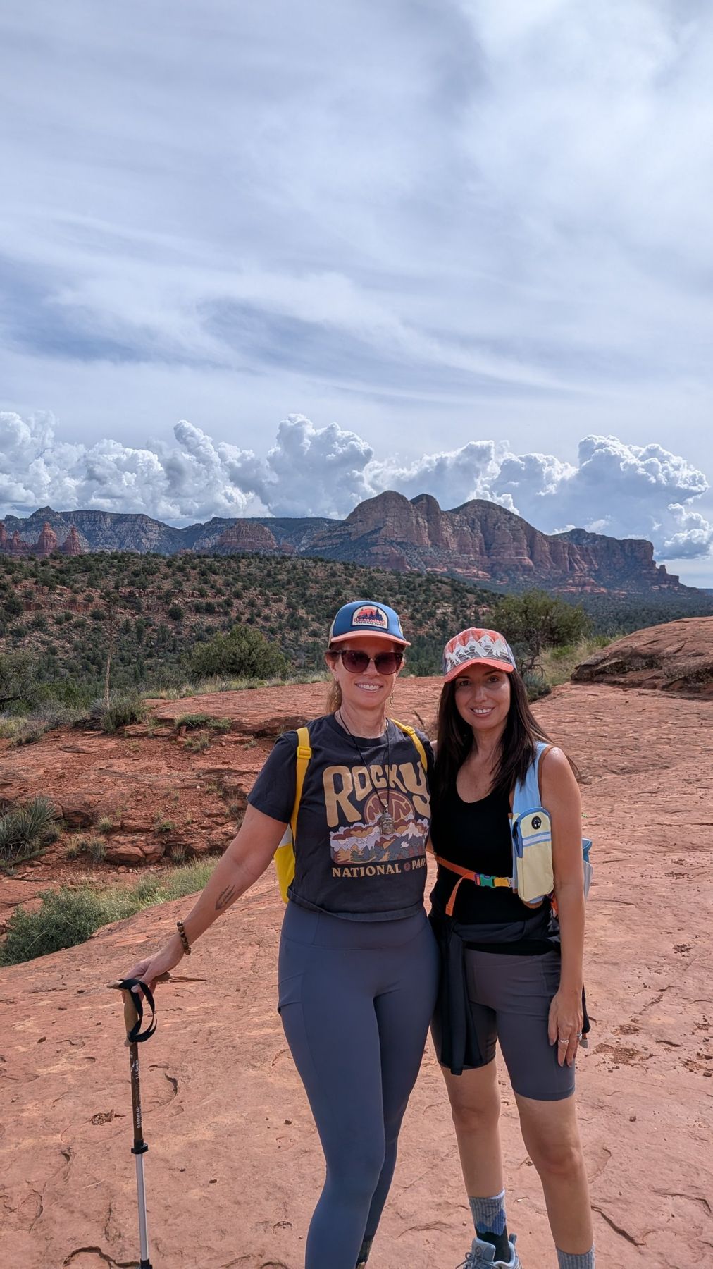 Marybeth and a friend smiling on a hike among Sedona's red rocks