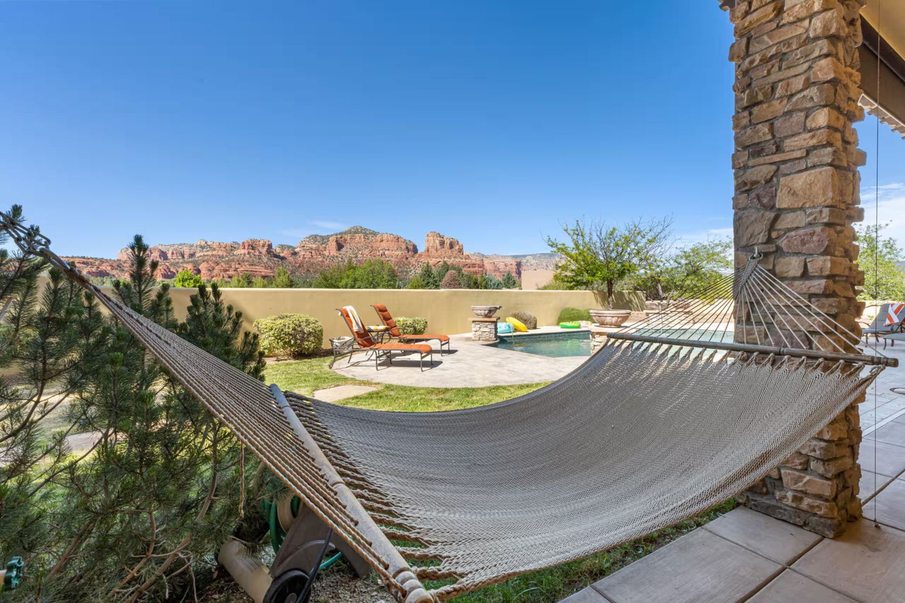 A hammock on the patio looking out at Sedona's red rocks